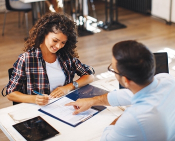 Employee Explaining Document to Customer