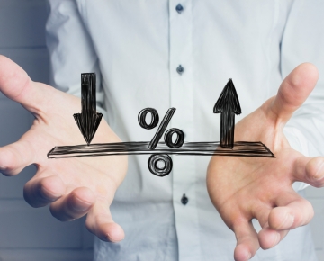 Man Holding Scale Representing Rates Changing