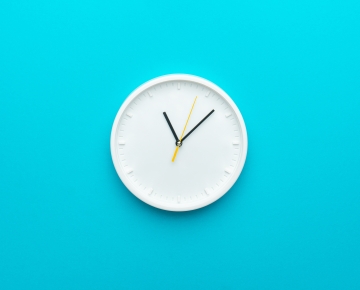 white clock on blue background