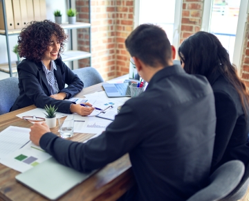 woman looking through paperwork with couple