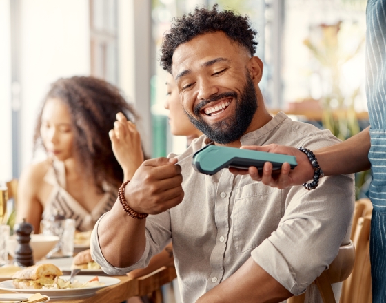 Man processing card transaction. 