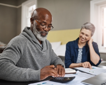 couple at table with papers and calculator