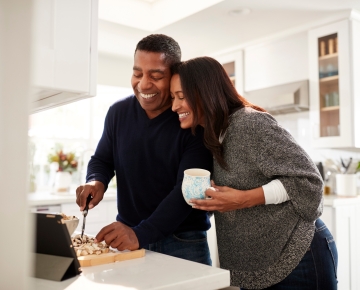 man and woman cooking together