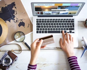 Person Booking Travel on Computer