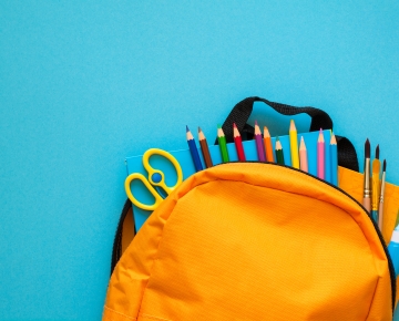 backpack with school supplies popping out